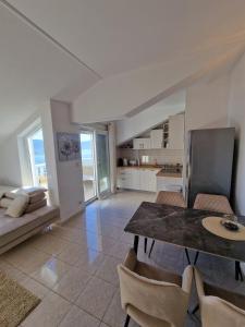 a kitchen and living room with a table and chairs at Compass Apartment in Trogir