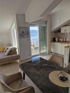 a living room with a table and a view of the ocean at Compass Apartment in Trogir