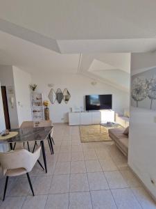 a living room with a table and a couch at Compass Apartment in Trogir