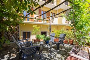 a patio with chairs and a table in front of a building at Il Cortile di Mamma Mia in Pisano