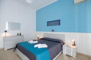 a bedroom with a bed and two night stands at Pozzallo yellow house,5'dal mare in Pozzallo