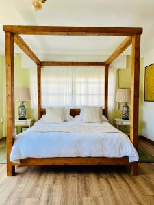 a bedroom with a large wooden bed with white sheets at Mar De Frisia in O Pino  +41 photos