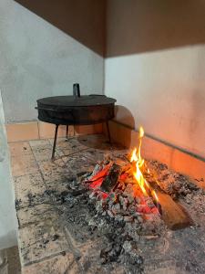 a table sitting next to a fire in a room at Departamentos Sato in Apóstoles