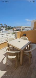 a table and chairs on a balcony with a view of the ocean at Frosos house in Kefalos