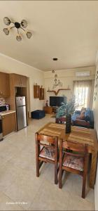 a living room with a table and a kitchen at Frosos house in Kefalos