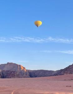 a kite flying in the sky over the desert at Wadi Rum Nader Luxury Camp in Wadi Rum