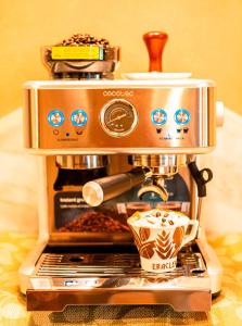 a coffee maker with a cup of coffee on top at B&B Il Glicine Molare in Cremolino