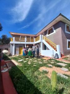 a group of people standing in front of a house at Musiña Lodge in Ocosuyo +15 photos