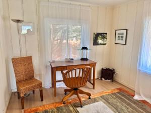 a desk and a chair in a room with a window at Ma Margarets House Bed and Breakfast in Reedville