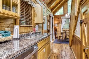 a kitchen with a sink and a counter at Barefoot Dreams in Sevierville +23 photos