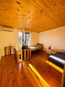 a bedroom with a bed and a wooden ceiling at Departamentos Sato in Apóstoles