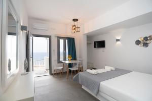 a bedroom with a bed and a dining room with a table at Galaxy studios in Astypalaia