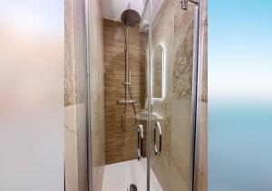 a shower with a glass door in a bathroom at L'olivier du vieil Antibes in Antibes
