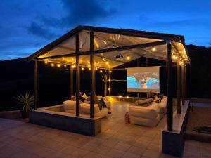 a gazebo with couches and a screen at Finca RustiQ in Torrox