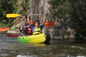 two people are in a kayak in the water at Jasmin et Camomille in Roquebrun