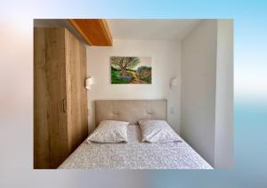 a bedroom with a bed in a white room at L'olivier du vieil Antibes in Antibes +9 photos
