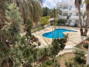 an image of a swimming pool in front of a building at Costamar 15 - Pool - 3 minutes to the beach in Es Pujols