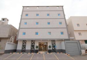 a tall building with a parking lot in front of it at Princess House in Jeddah