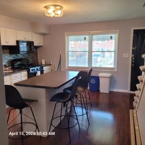 a kitchen with a island with bar stools at The Haven in Dundalk