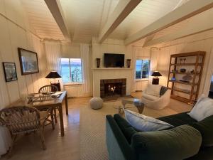 a living room with a couch and a fireplace at Ma Margarets House Bed and Breakfast in Reedville