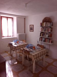 a living room with two tables and a book shelf at Casa del Gigi BnB in Albareto +33 photos