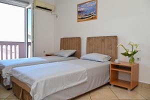 two beds sitting next to each other in a room at Apartments Porto Bjelila in Tivat