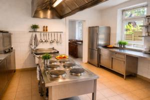 a kitchen with stainless steel appliances in a kitchen at Wildes Amrum Island Basecamp Backpacker & Nature Stay in Norddorf