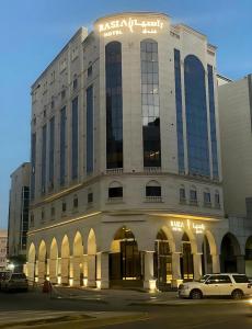 a building with a car parked in front of it at فندق راسيا in Medina