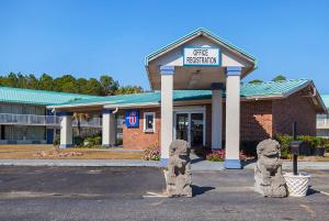 a building with a sign that reads fire station at Motel 6-Tifton, GA in Tifton