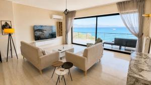a living room with a view of the ocean at Seafront Luxury Apartment in Kalamata
