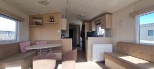 a kitchen and living room with a table and chairs at E21 The Sandy Heaven in Lossiemouth +6 photos