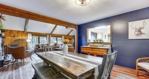 a dining room with a table and a living room at Pine Loch, sleeps 9, 3 bedroom, 2 bath, gas fire pit on deck in Pocono Lake