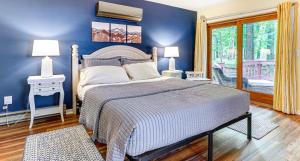 a blue bedroom with a bed and a window at Pine Loch, sleeps 9, 3 bedroom, 2 bath, gas fire pit on deck in Pocono Lake +17 photos