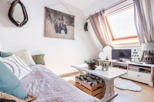 a bedroom with a bed and a table with a tv at Chalet Les Angles in Les Angles