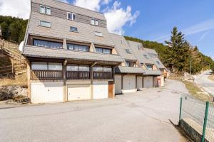 a large building with two garages in front of it at Chalet Les Angles in Les Angles