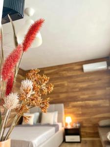 a living room with a white couch and flowers at Sunset Yavorov Pomorie in Pomorie