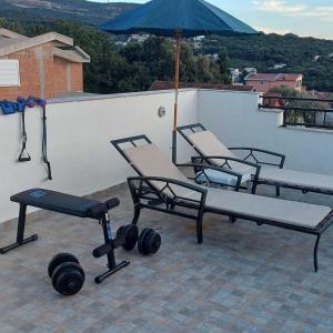 a group of chairs and weights on a roof at Villa Milka in Utjeha