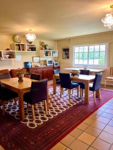 a living room with tables and chairs on a rug at Mar De Frisia in O Pino 