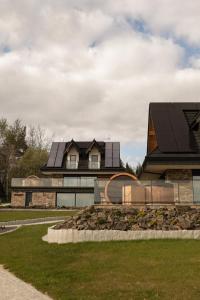 a house with solar panels on top of it at Gorczański Lux Chalet in Szlembark