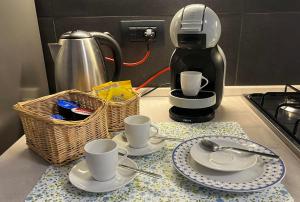 a kitchen counter with two cups and a coffee maker at A Casa di Laura in Parella