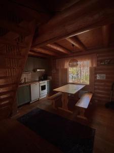 a kitchen with a table and a window in a cabin at Kalliorinteen Mökit Ruskapirtti in Töysä