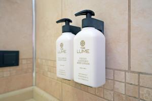 two white bottles of soap on the wall of a bathroom at Casa Lume in Bodrum City +48 photos
