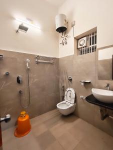 a bathroom with a toilet and a sink at Maa Ambika Royal House in Baripāda +37 photos