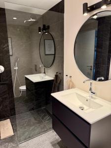 a bathroom with two sinks and a large mirror at Fagraberg in Hafnarfjörður +18 photos