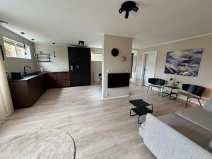 a living room with a couch and a kitchen at Fagraberg in Hafnarfjörður