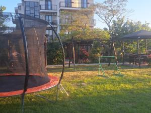 an empty playground with two swings in the grass at Apartmani Moco in Ulcinj