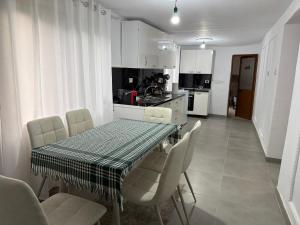 a kitchen and dining room with a table and chairs at Canyon River House in Çorovodë
