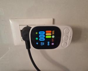 an iphone plugged into an outlet with a cord at Elycon House Bergamo - Locazione turistica a camere in Bergamo