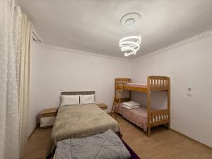a bedroom with two beds and a ceiling at Canyon River House in Çorovodë +22 photos