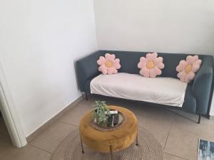 a living room with a couch with flowers on it at Apartman deluxe sea in Split